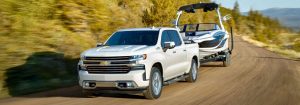 Front three-quarter view of the 2020 Chevrolet Silverado towing a speed boat