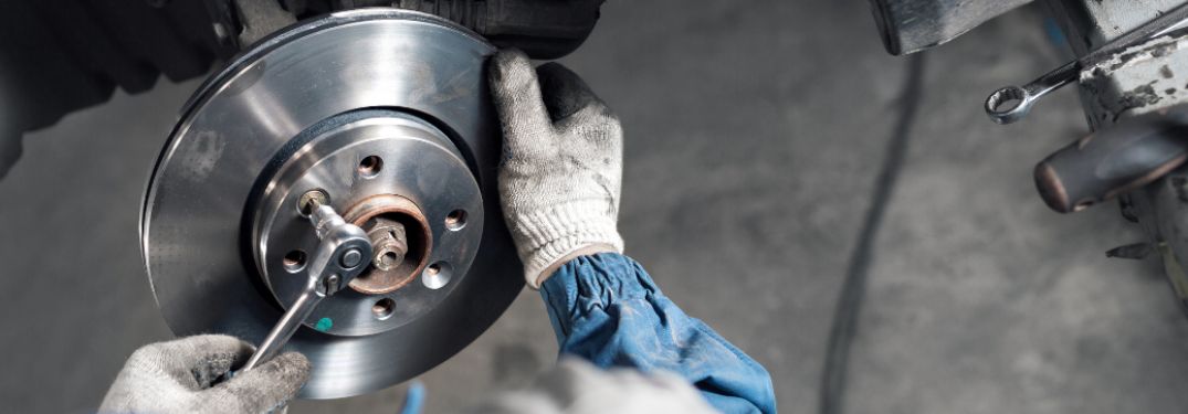 Technician repairing brake of a vehicle
