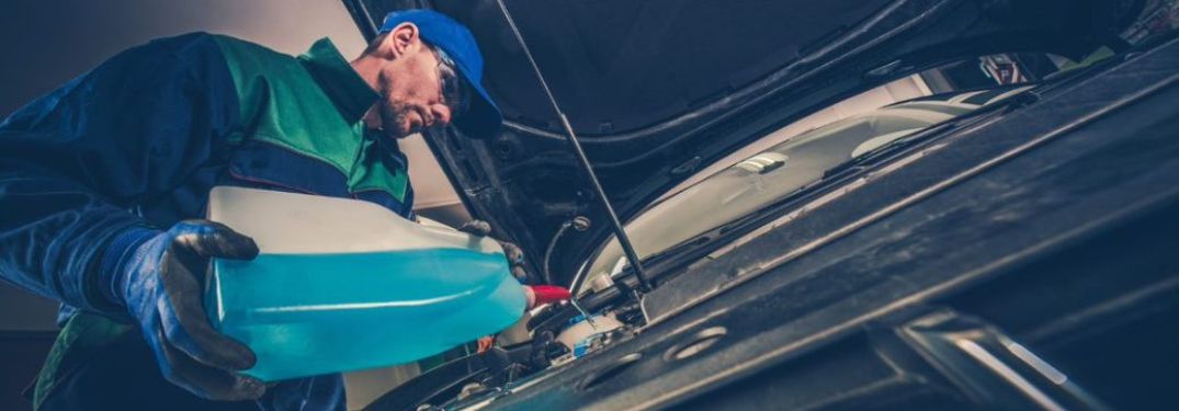 Mechanic pouring fluid