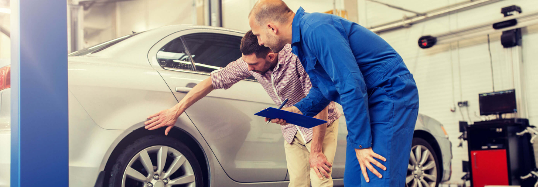 Customer showing something to mechanic