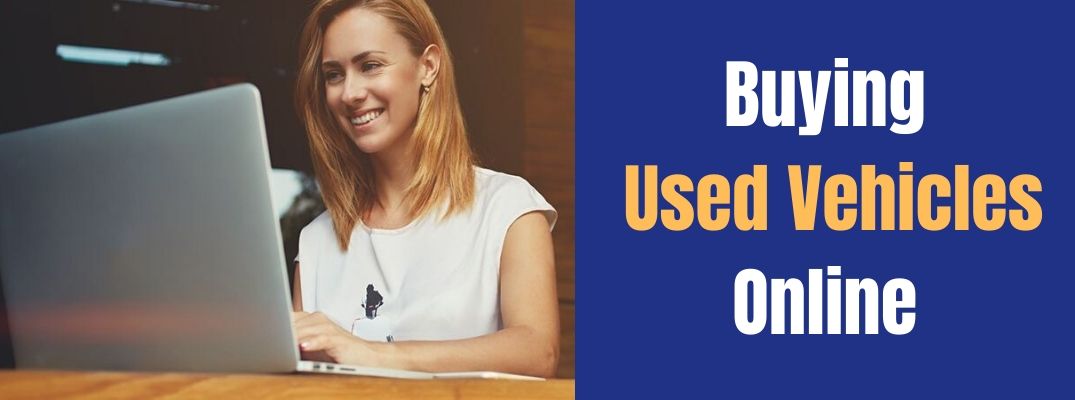 Buying Used Vehicles Online banner with an image of a woman using a computer