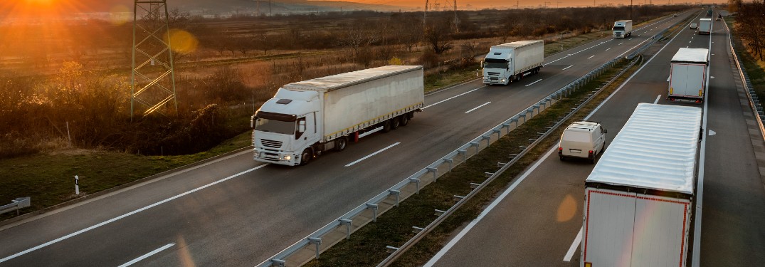 cars and semi trucks driving on split highway