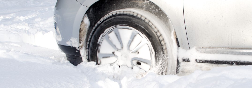 close up of car driving through thick snow