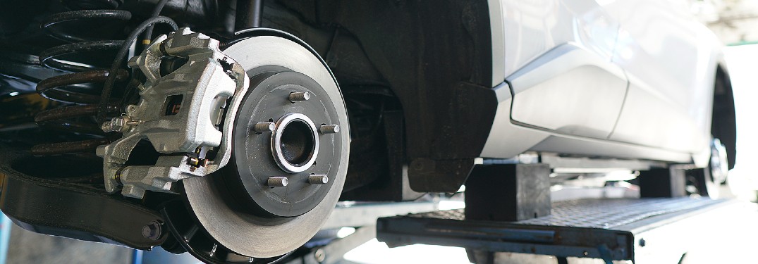 car in shop with brake disc exposed
