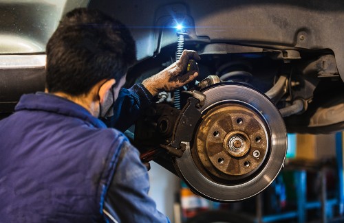 mechanic fixing brake rotor of car