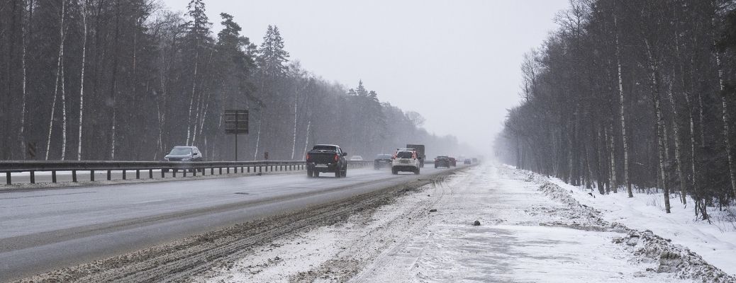 Trucks and SUVs on a highway during winter