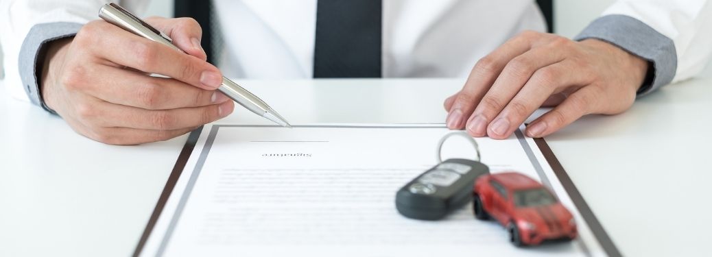 Customer signing car loan lease document