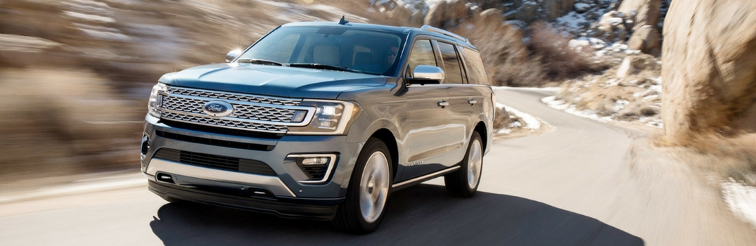 2018 Ford Expedition driving down a road.