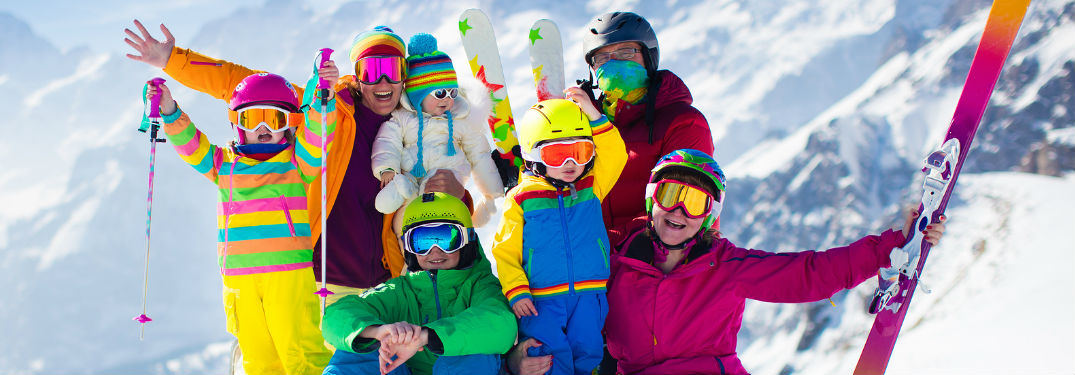 Family wearing coats with skis