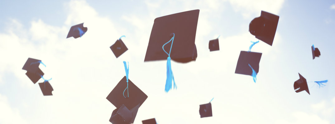 Graduation caps in the air