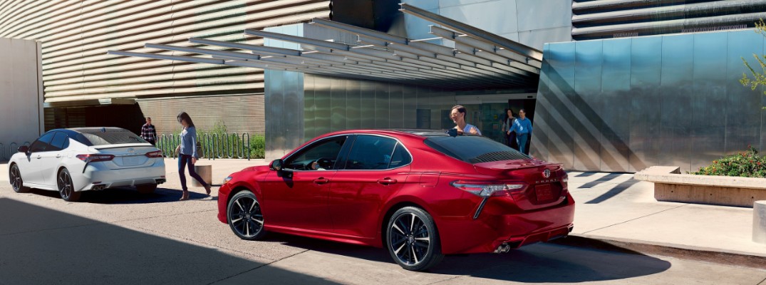 2020 Toyota Camry parked in front of a modern hotel