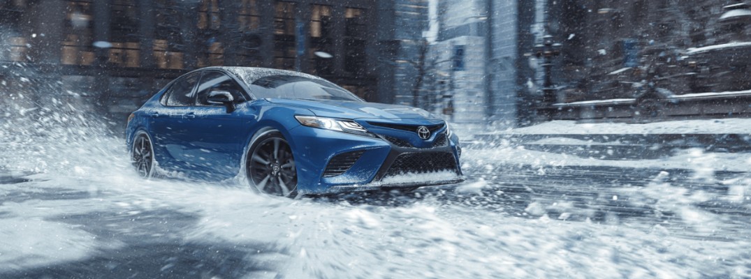 2020 Toyota Camry driving through snow downtown