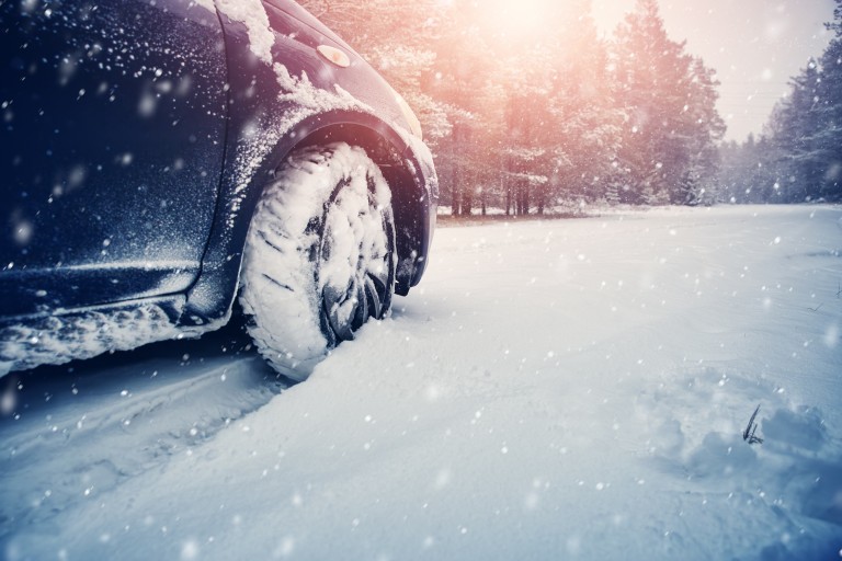A car tire stock in the snow