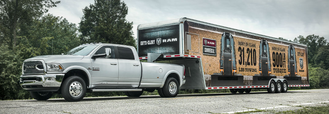 Driver side exterior view of a white 2017 Ram 2500 towing a large trailer