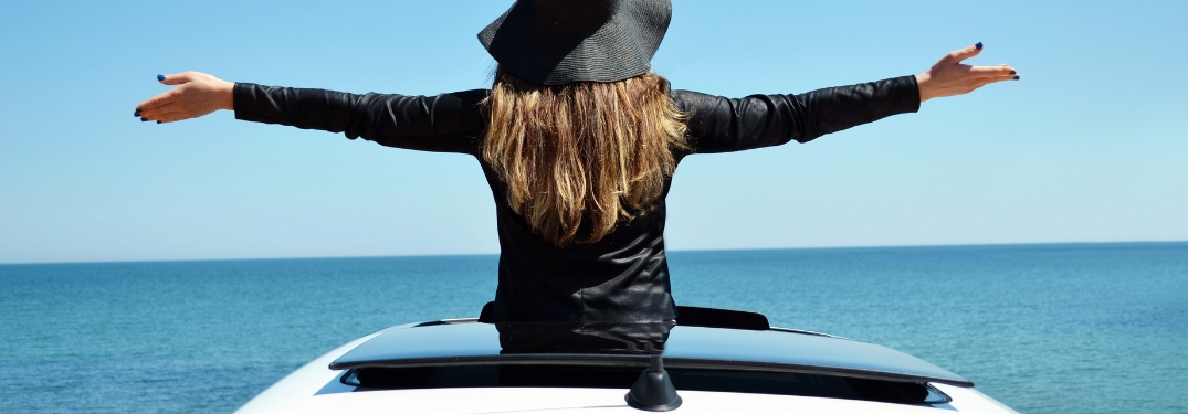 woman poking torso out of moonroof