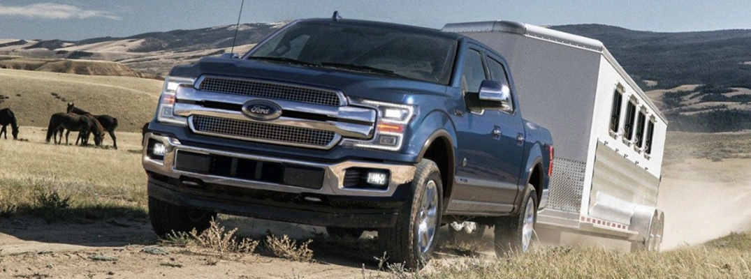 Blue 2019 Ford F-150 towing trailer