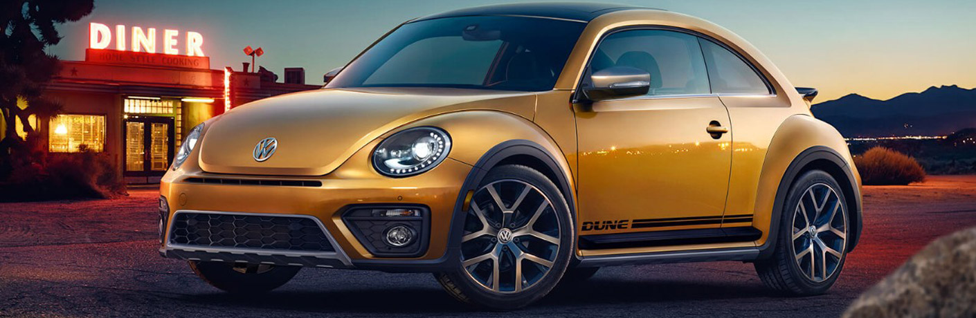 Gold 2018 Volkswagen Beetle parked in front of a diner