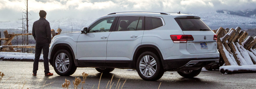 Man standing next to a parked 2018 Volkswagen Atlas
