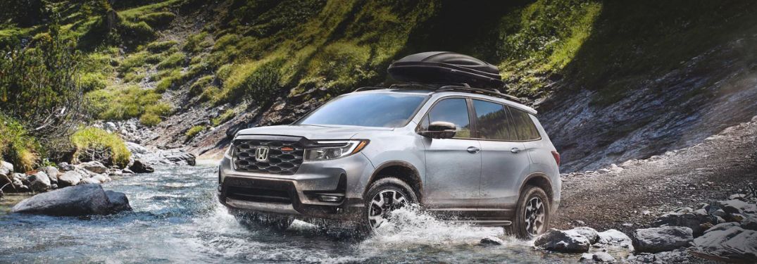 An image of the side view of a grey colored 2022 Honda Passport.