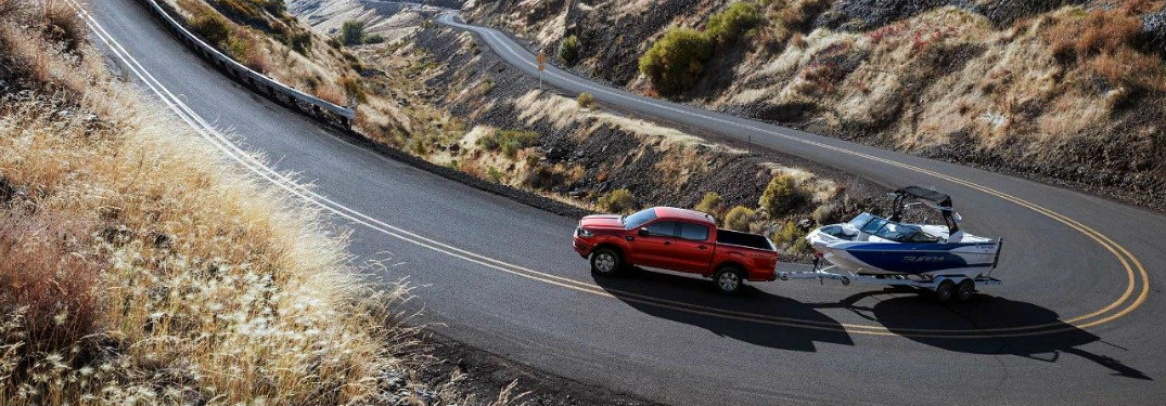 red-2019-Ford-Ranger-towing-boat-up-mountain-road