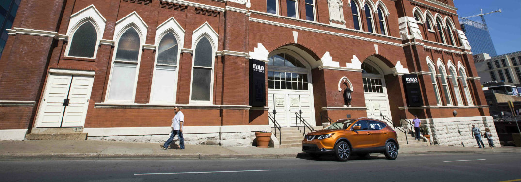 orange rogue sport in front of big brick building