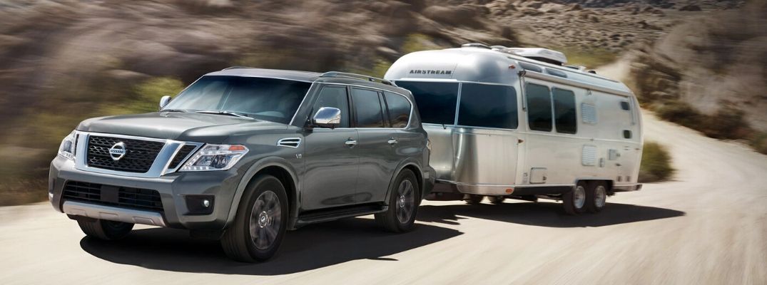 Exterior view of a gray 2020 Nissan Armada towing a travel trailer