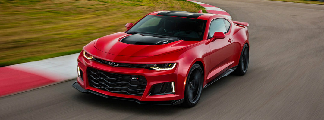 Red 2017 Chevy Camaro driving on a racetrack