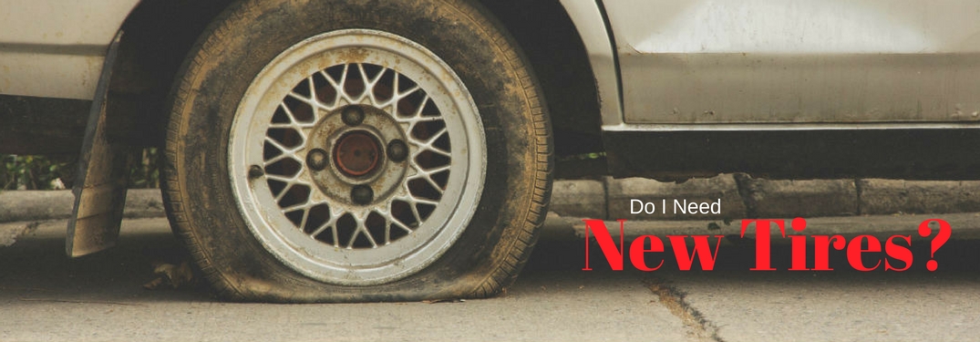 Do I need new tires?, text on an image of a car with a flat tire