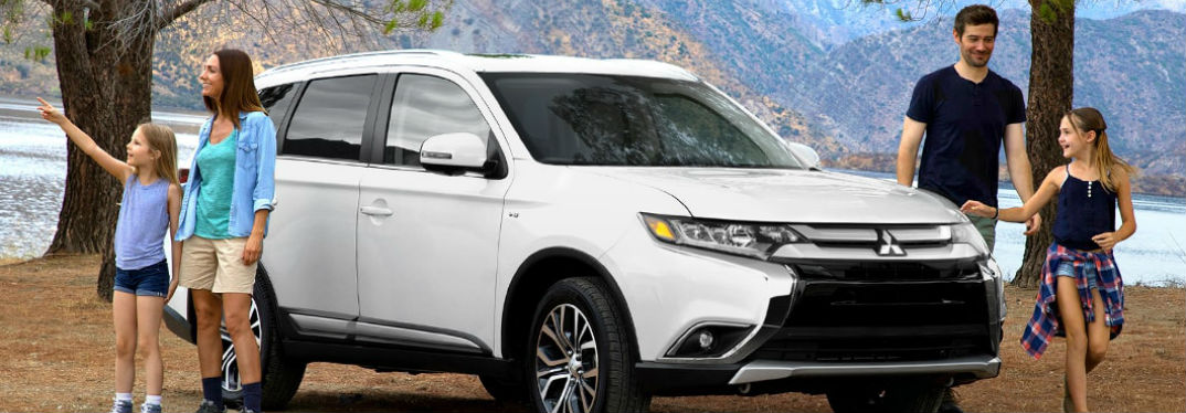 New Mitsubishi Models for Camping with image of a 2018 Mitsubishi Outlander with a family camping