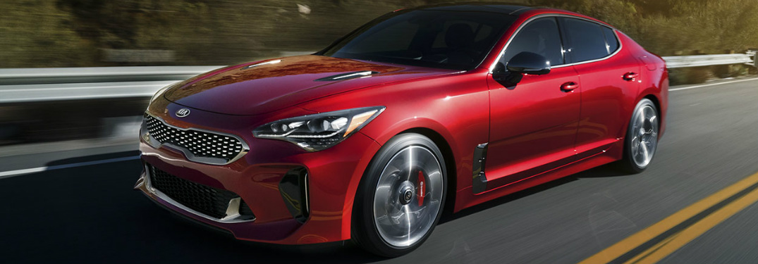 2018 Kia Stinger exterior in red driving down the highway