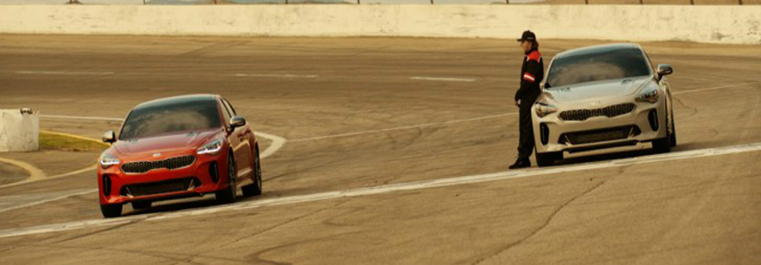 2018 Kia Super Bowl tease with Emerson Fittipaldi standing on a race track with the Kia Stinger