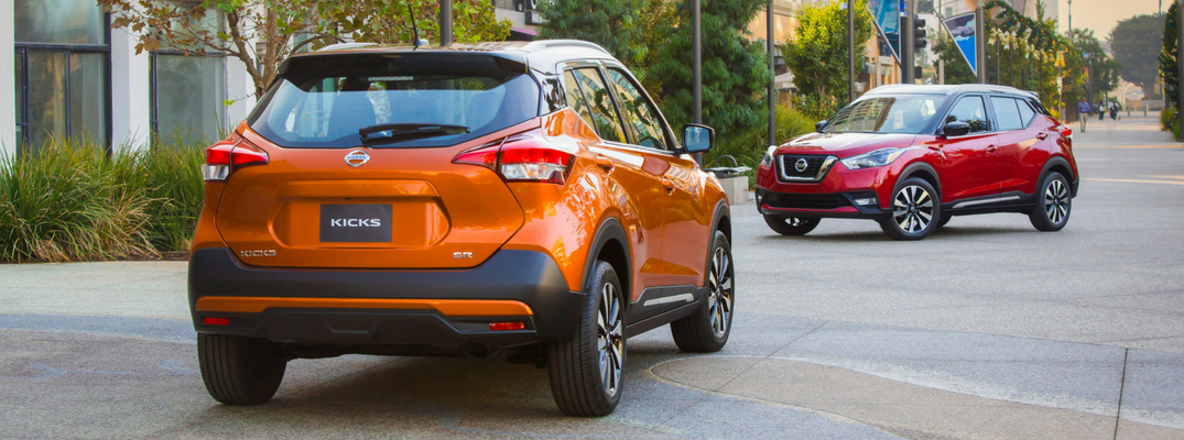 2018 Nissan Kicks Rear View of Orange Exterior and Front View of Red Exterior