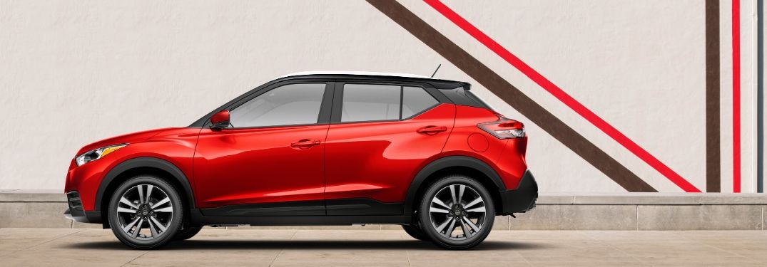 Red 2020 Nissan Kicks parked in front of building from exterior drivers side