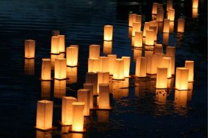 Floating lanterns in water at night