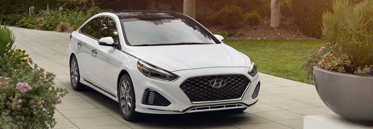White 2019 Hyundai Sonata parked in residential driveway