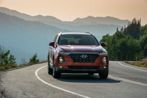 Red 2020 Hyundai Santa Fe from front view with mountains in background