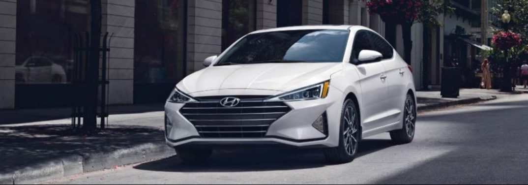 White 2020 Hyundai Elantra parked by a sidewalk.