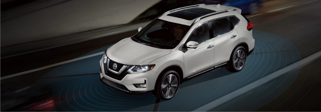 Graphic of White Nissan Rogue on a Highway with Nissan ProPILOT Assist Sensors Around the Vehicle