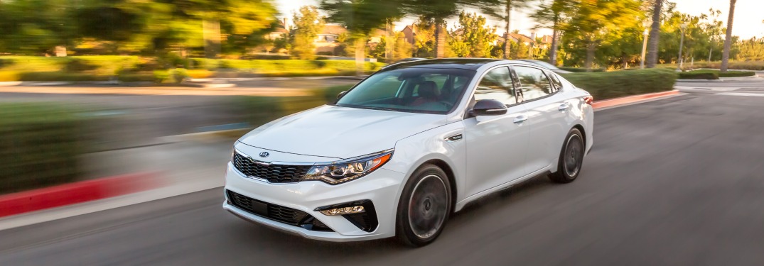 2020 Kia Optima driving down a suburban road