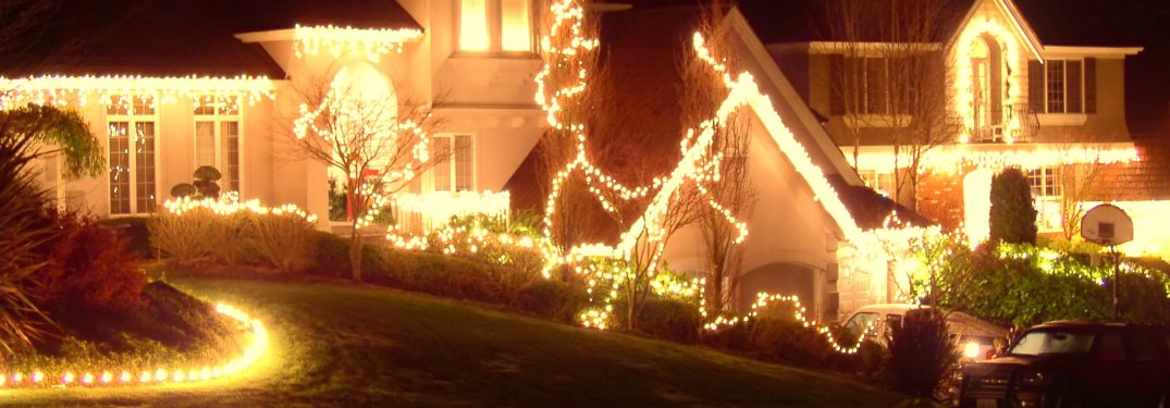 A row of houses decorated with Christmas lights