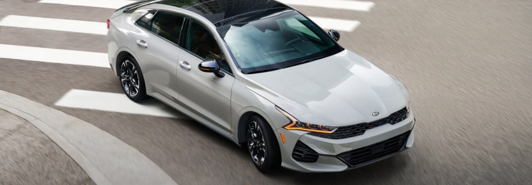 2021 Kia K5 driving down a city street