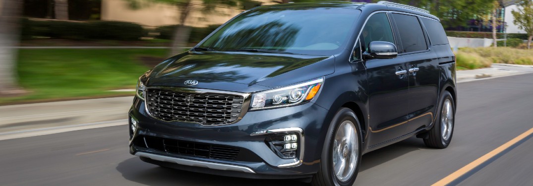 2021 Kia Sedona driving down a city street