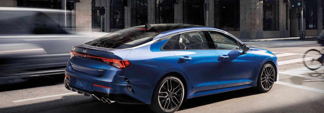 2021 Kia K5 driving down a city street