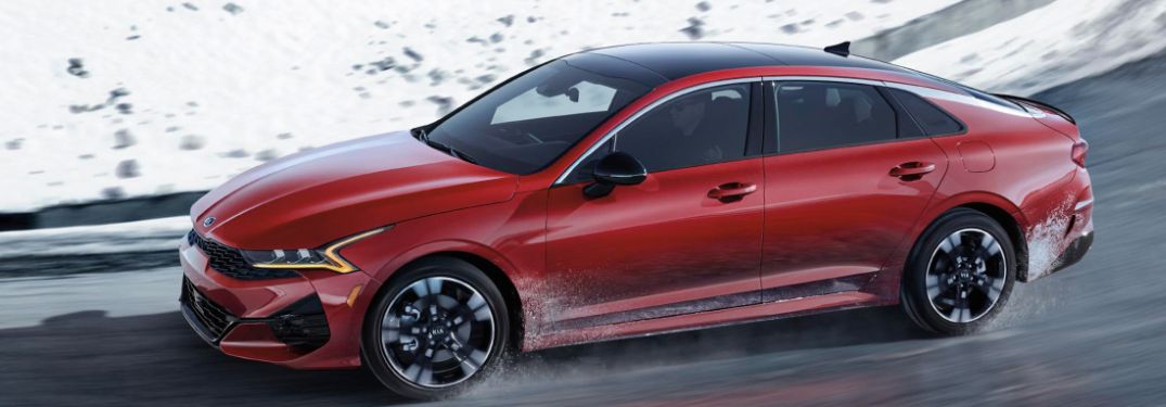 2021 Kia K5 driving down a snowy road
