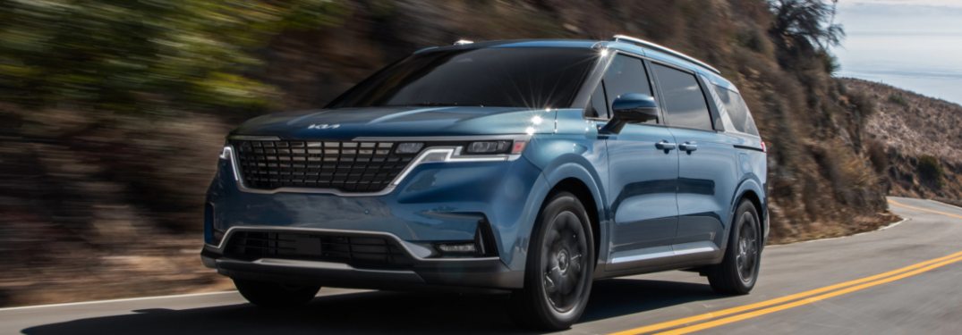 2022 Kia Carnival driving down a mountain road