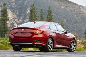 Back of red 2020 Honda Civic Sedan Touring from exterior passenger side view