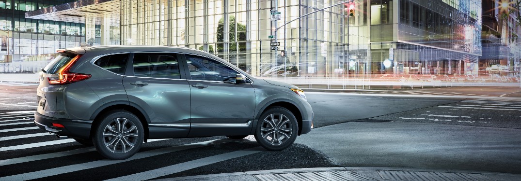 2020 Honda CR-V Touring grey driving through city at night