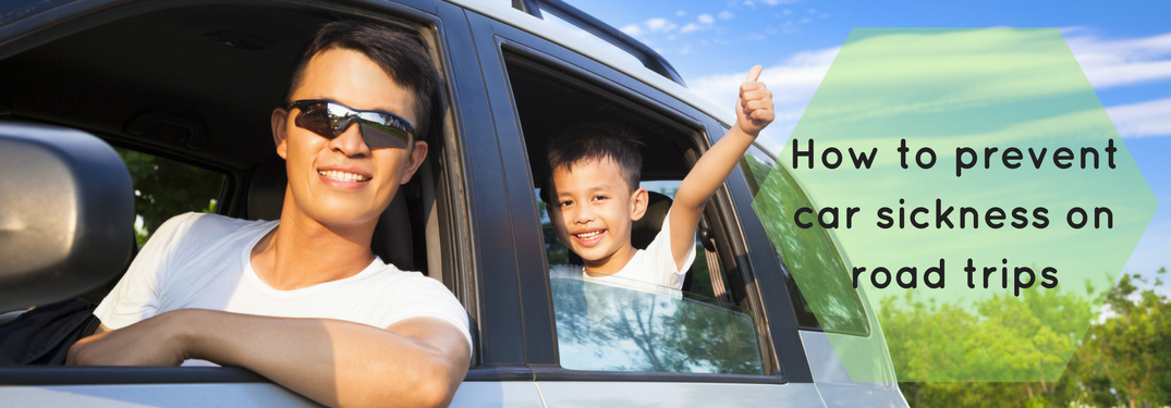 man and child in car, how to prevent car sickness on road trips