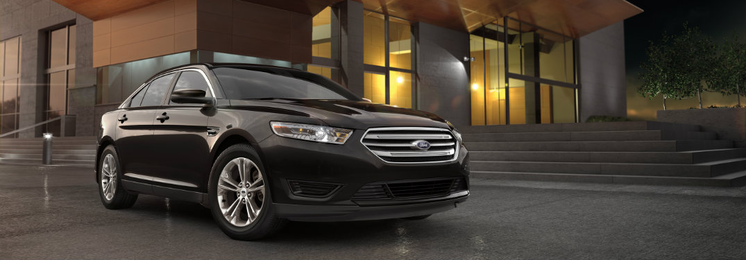 black ford taurus parked outside building