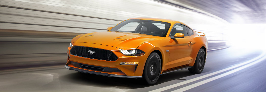 orange ford mustang in tunnel